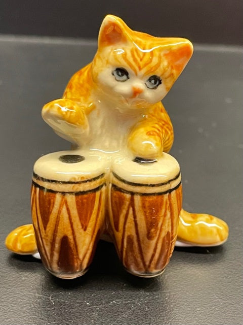 Porcelain Ginger Cat Playing the Bongos.