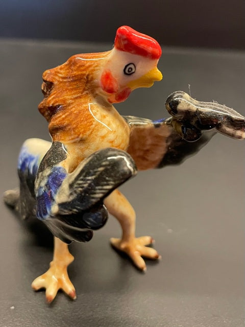 Porcelain Rooster Singing with a Microphone.