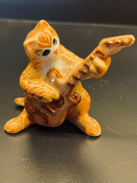 Porcelain Ginger Cat Playing the Guitar