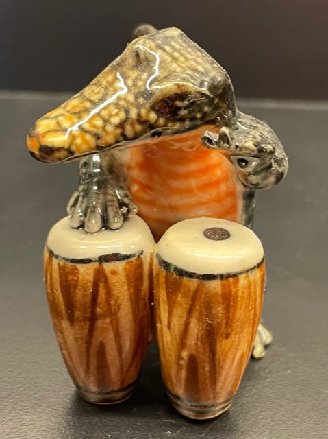 Porcelain Crocodile Playing the Bongos.