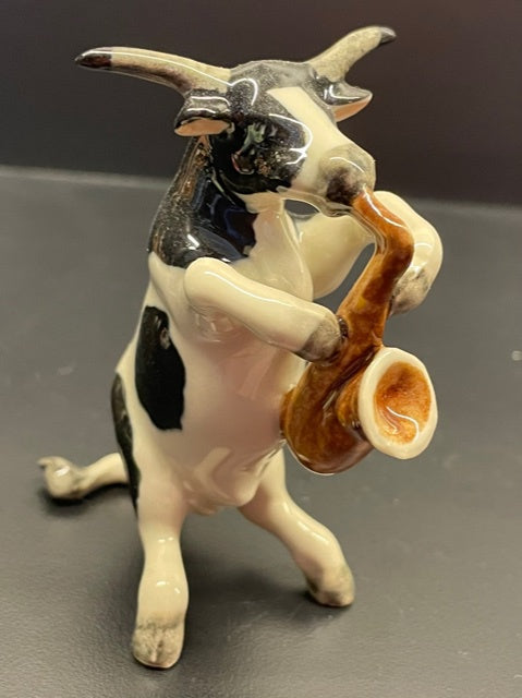 Porcelain Cow Playing the Saxophone.