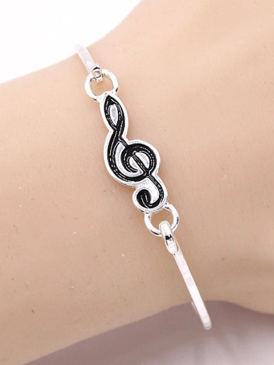 Silver Metal Casting Bangle Featuring an Epoxy Black Treble Clef